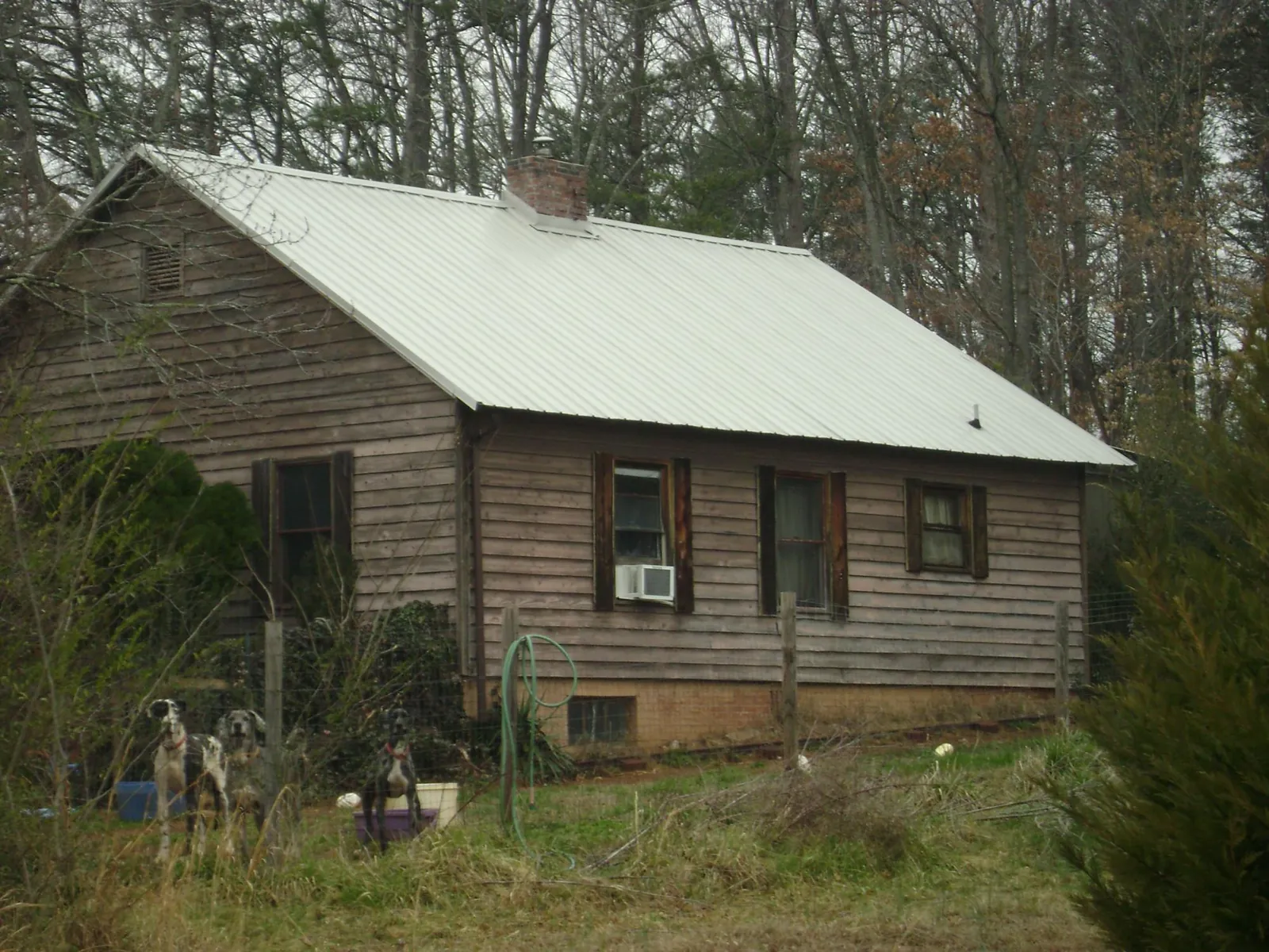 White metal roof on an old wood sided farmhouse, from a Metal Roof Installation job in Bowerston